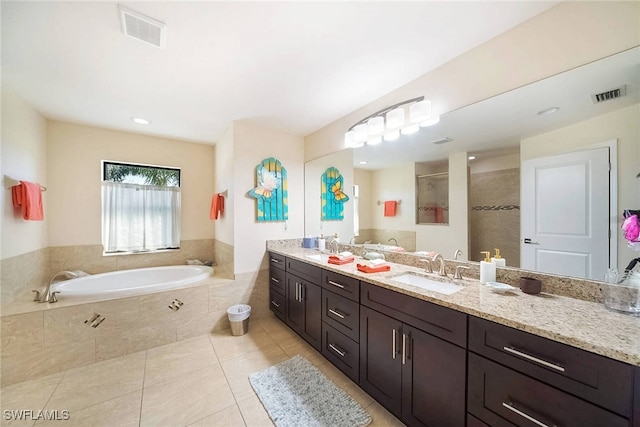 full bath featuring a bath, visible vents, a tile shower, and a sink