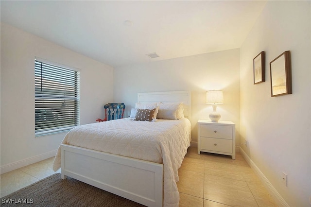 bedroom featuring light tile patterned flooring, visible vents, and baseboards