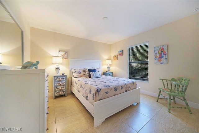 bedroom with baseboards and light tile patterned floors