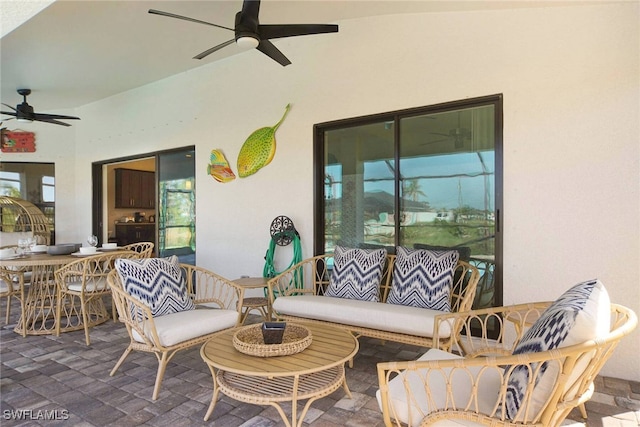 view of patio / terrace with a ceiling fan, outdoor dining space, and an outdoor living space