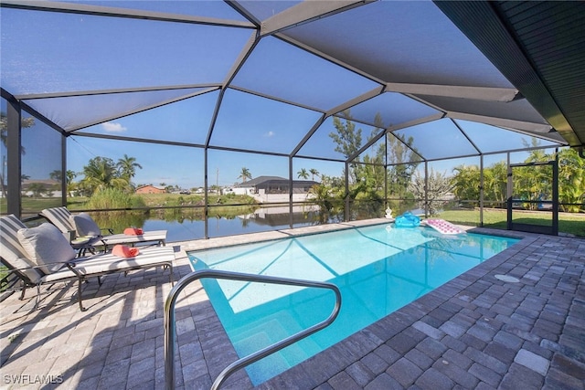 outdoor pool featuring a water view, glass enclosure, and a patio