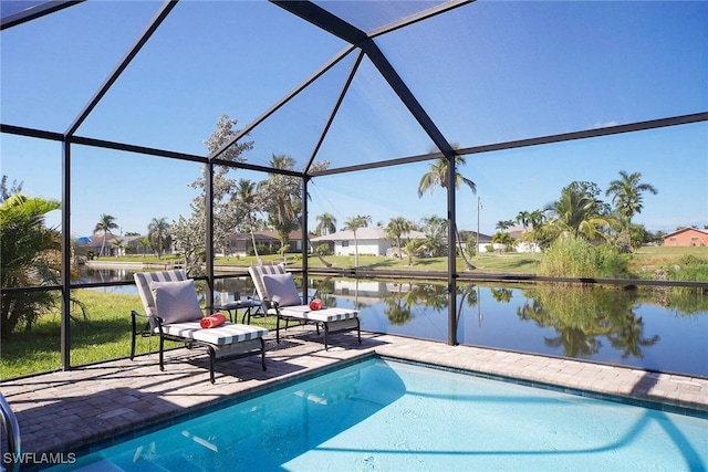 outdoor pool with a water view, a patio area, and a lanai