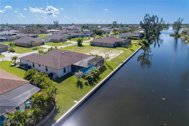 bird's eye view featuring a water view and a residential view