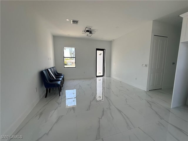 interior space with marble finish floor, visible vents, and baseboards