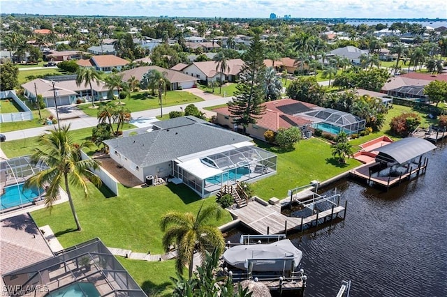 drone / aerial view with a residential view and a water view