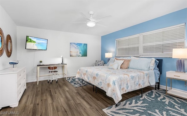 bedroom featuring ceiling fan, baseboards, and wood finished floors