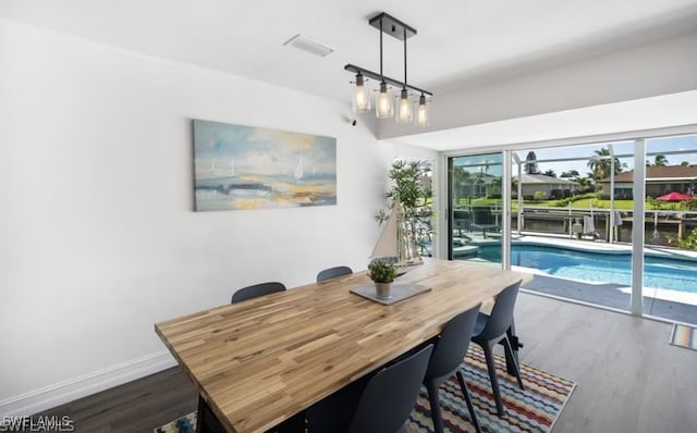 dining area with dark wood-style floors and baseboards