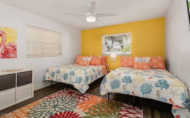 bedroom featuring ceiling fan, wood finished floors, and baseboards