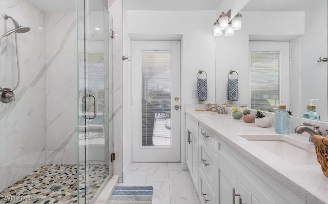 bathroom featuring marble finish floor, a sink, and a marble finish shower