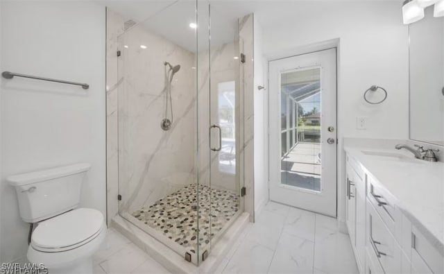 bathroom with a marble finish shower, marble finish floor, vanity, and toilet