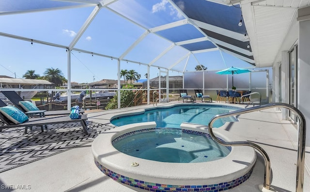 view of swimming pool with glass enclosure, a pool with connected hot tub, and a patio