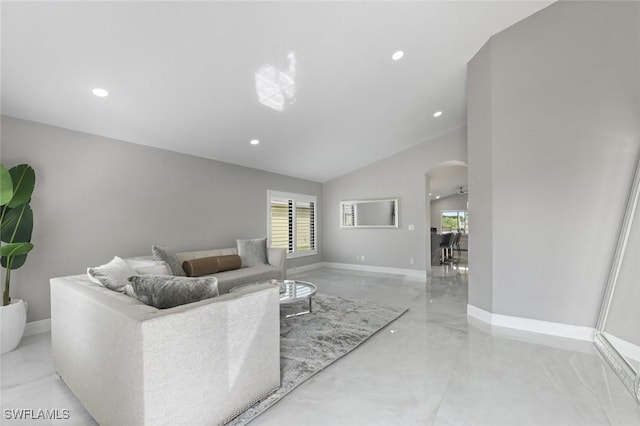 living room featuring arched walkways, high vaulted ceiling, recessed lighting, and baseboards