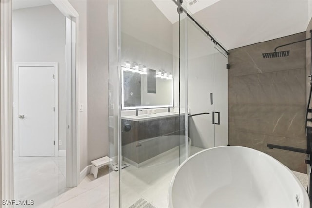 bathroom featuring a soaking tub, a sink, and a shower stall