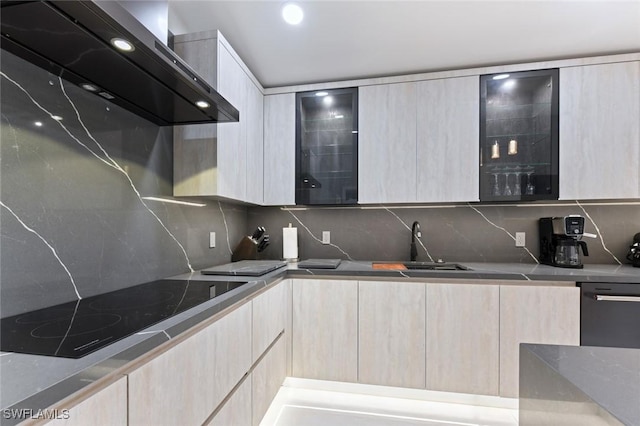 kitchen with modern cabinets, black electric cooktop, and exhaust hood