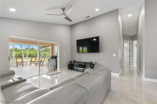 living room with marble finish floor, a high ceiling, baseboards, and a ceiling fan