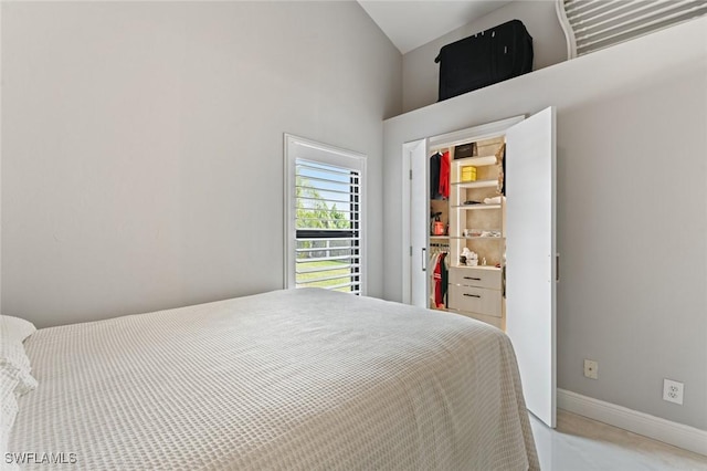 bedroom featuring a closet, vaulted ceiling, and baseboards