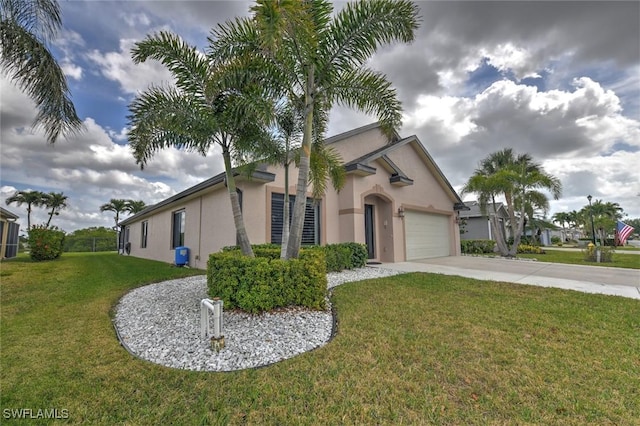 view of front of home featuring a garage, concrete driveway, a front lawn, and stucco siding