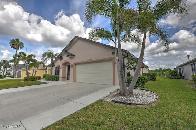 view of front of home with a garage, concrete driveway, a front lawn, and stucco siding