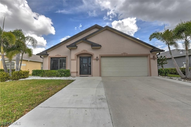 view of front of property featuring an attached garage, a front yard, concrete driveway, and stucco siding