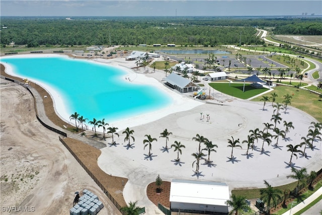 aerial view featuring a water view and a view of trees