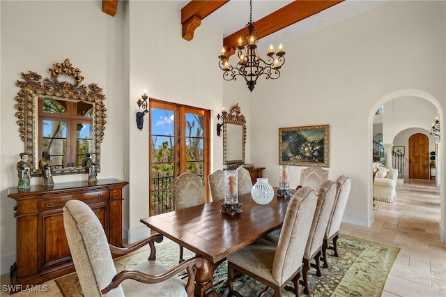 dining room featuring arched walkways, a notable chandelier, a high ceiling, beamed ceiling, and stone tile flooring