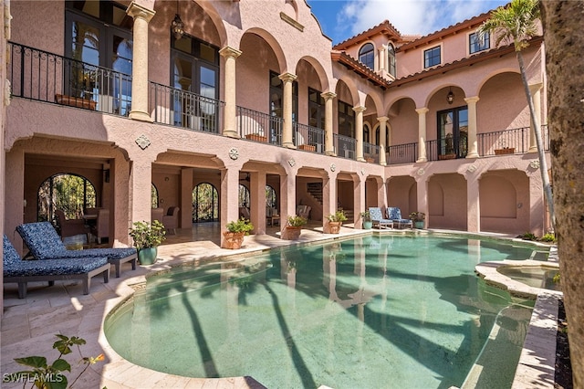 view of swimming pool with a pool with connected hot tub and a patio area