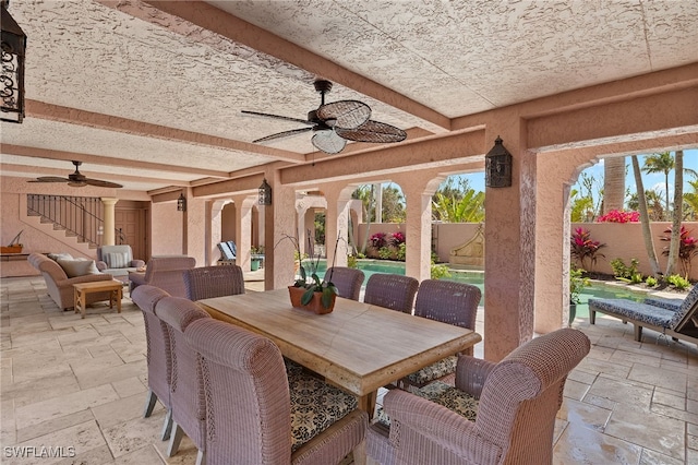 view of patio with outdoor dining space, a fenced backyard, and ceiling fan