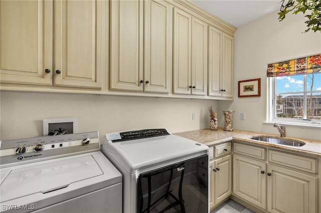 laundry room featuring washer and clothes dryer, a sink, and cabinet space