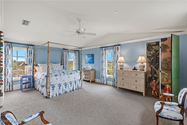 carpeted bedroom featuring ceiling fan, visible vents, vaulted ceiling, and multiple windows