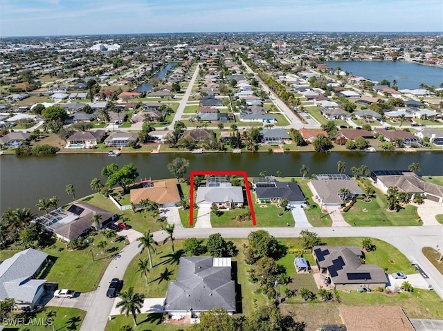 birds eye view of property featuring a residential view and a water view