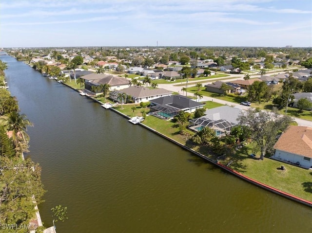 drone / aerial view featuring a residential view and a water view