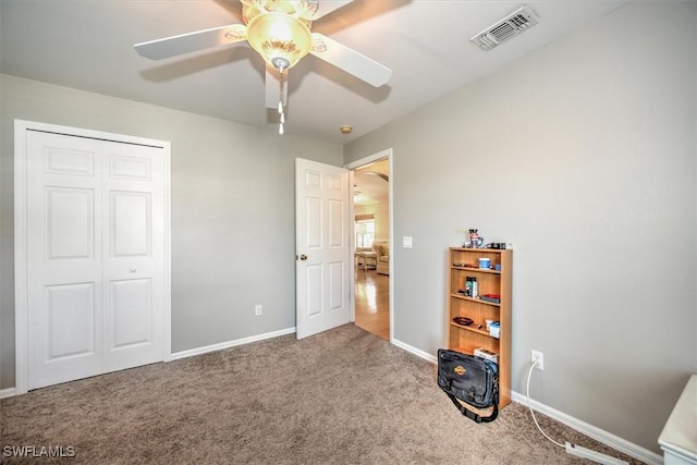 unfurnished bedroom featuring baseboards, carpet, visible vents, and a closet