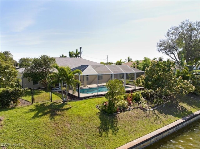 exterior space with an outdoor pool, glass enclosure, a water view, a gate, and a yard