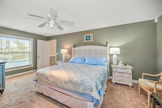 carpeted bedroom with a ceiling fan and baseboards