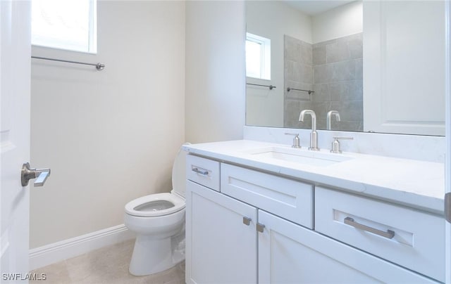 full bath with vanity, toilet, and baseboards