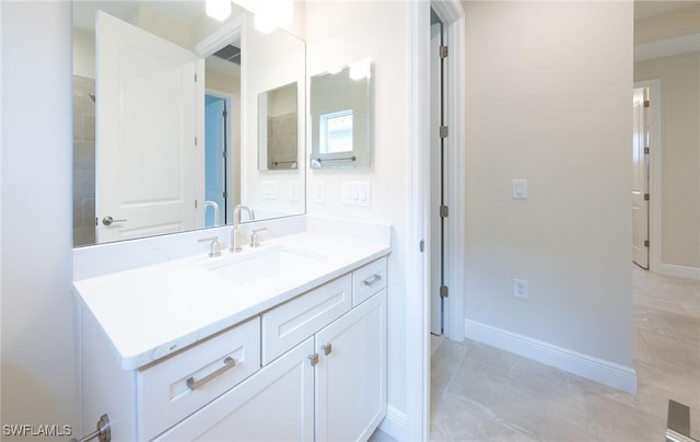 bathroom with visible vents, baseboards, and vanity