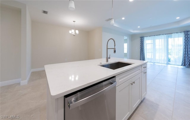 kitchen featuring a sink, a kitchen island with sink, light countertops, and stainless steel dishwasher