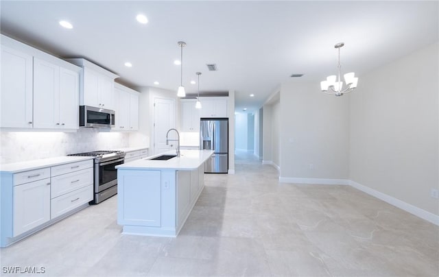 kitchen with a kitchen island with sink, stainless steel appliances, a sink, visible vents, and white cabinets