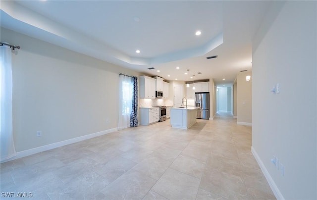 kitchen with recessed lighting, visible vents, appliances with stainless steel finishes, open floor plan, and an island with sink