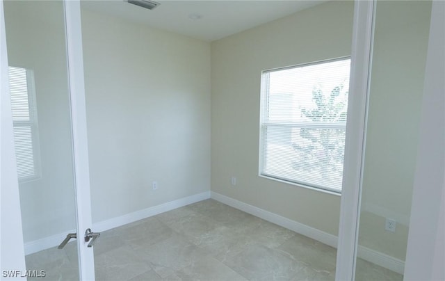 empty room featuring visible vents and baseboards