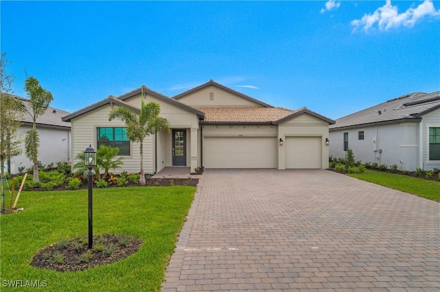 ranch-style house featuring an attached garage, a tiled roof, decorative driveway, stucco siding, and a front lawn