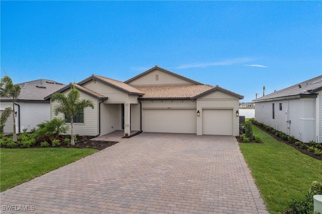 single story home with a front yard, decorative driveway, a tiled roof, and an attached garage