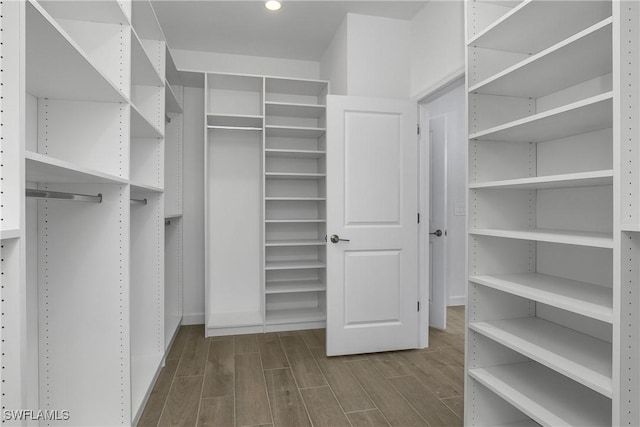 walk in closet with wood tiled floor