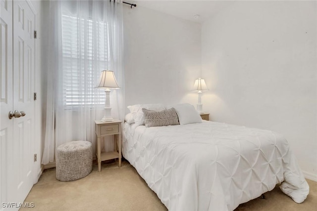 bedroom featuring light carpet