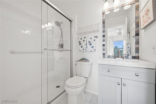 full bath featuring toilet, a shower stall, vanity, tile patterned flooring, and baseboards