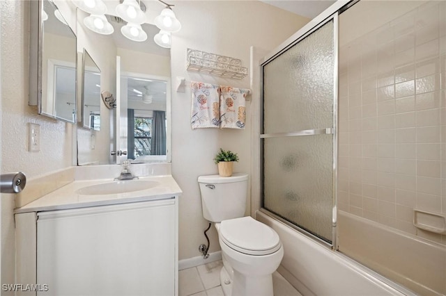 bathroom with tile patterned flooring, toilet, bath / shower combo with glass door, vanity, and baseboards