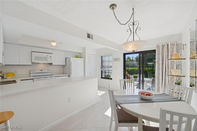 dining room featuring visible vents, a textured ceiling, and light tile patterned floors