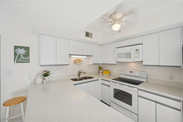 kitchen featuring light countertops, visible vents, white cabinets, a sink, and white appliances