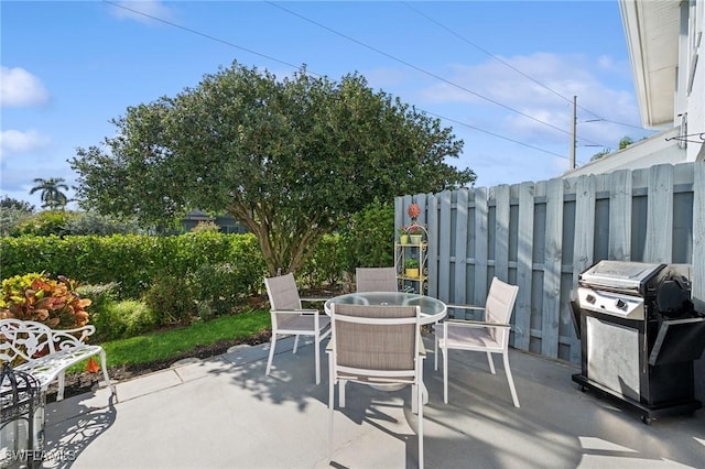 view of patio / terrace with outdoor dining space, area for grilling, and fence