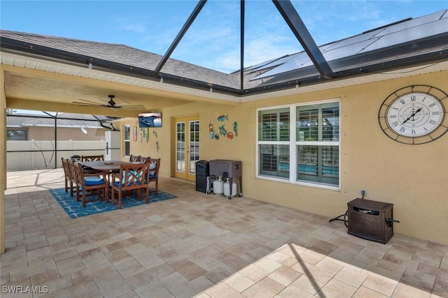 view of patio / terrace featuring ceiling fan, french doors, a lanai, and fence